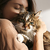 Woman hugging furry cat